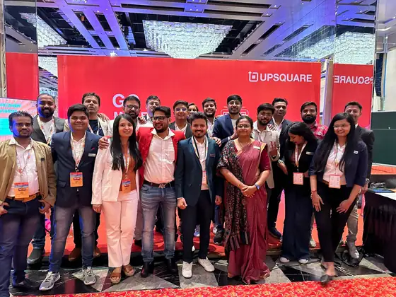 Exhibition team group photo on the Upsquare stand at a trade show